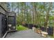 Charming backyard deck with view of landscaped yard, black fence, and mature trees, offering a peaceful retreat at 80 26Th Nw St, Atlanta, GA 30309