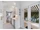 Stylish bar area with glass-front cabinets, beverage coolers, and views of the outdoor pool area at 80 26Th Nw St, Atlanta, GA 30309