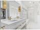 Bathroom with double vanity, white marble, gold hardware, and storage at 80 26Th Nw St, Atlanta, GA 30309
