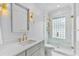 Modern bathroom with glass-enclosed shower, marble vanity, and gold accents at 80 26Th Nw St, Atlanta, GA 30309
