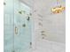 Bright bathroom features glass shower and soaking tub with gold hardware at 80 26Th Nw St, Atlanta, GA 30309