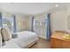 Bedroom with natural light, wooden dresser, and white bedding at 80 26Th Nw St, Atlanta, GA 30309