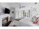 Bright bedroom features fireplace, ceiling fan, and French doors leading to a balcony at 80 26Th Nw St, Atlanta, GA 30309