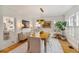 Elegant dining room with modern chandelier, white chairs, and hardwood floors at 80 26Th Nw St, Atlanta, GA 30309