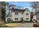Charming two-story white brick home featuring classic architecture and a beautifully landscaped front yard at 80 26Th Nw St, Atlanta, GA 30309