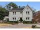 Stately two-story white brick home boasts a manicured lawn and an inviting entrance at 80 26Th Nw St, Atlanta, GA 30309