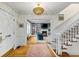 Bright foyer with hardwood floors, a staircase, and an open view to the living room with built-in bookshelves at 80 26Th Nw St, Atlanta, GA 30309