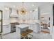 Well-lit kitchen featuring white cabinetry, stainless steel appliances, and an island with seating at 80 26Th Nw St, Atlanta, GA 30309