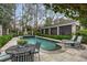 Relaxing pool area featuring elegant chaise lounges, a table, and lush landscaping, creating a serene outdoor oasis at 80 26Th Nw St, Atlanta, GA 30309