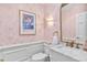 Chic powder room with gold accents, floral wallpaper, and marble countertop at 80 26Th Nw St, Atlanta, GA 30309
