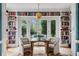 Cozy sitting area with built-in bookshelves and french doors offering a view of the pool at 80 26Th Nw St, Atlanta, GA 30309