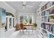 Bright sunroom with white brick walls, large windows, built-in bookshelves, and marble floors at 80 26Th Nw St, Atlanta, GA 30309