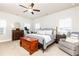 Bright bedroom features a ceiling fan, neutral walls and stylish furnishings at 830 Corsiglia Farm, Marietta, GA 30060