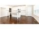 Modern kitchen featuring an island, white cabinetry, and hardwood flooring at 830 Corsiglia Farm, Marietta, GA 30060