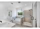 Bathroom featuring a separate shower, tub, double sinks, and access to the toilet room for enhanced privacy at 1356 Auburn Glen Rd, Dacula, GA 30019