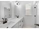 Bathroom with double vanity, modern fixtures, and a window for natural light at 1356 Auburn Glen Rd, Dacula, GA 30019