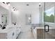 Bright bathroom featuring dual sinks, a glass-enclosed shower, and a separate soaking tub at 1356 Auburn Glen Rd, Dacula, GA 30019
