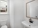 Small half bathroom with white walls, toilet and sink at 1356 Auburn Glen Rd, Dacula, GA 30019