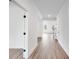 Bright hallway features hardwood floors, white walls, and views into the open-concept living spaces at 1356 Auburn Glen Rd, Dacula, GA 30019
