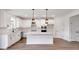 Beautiful kitchen featuring white cabinets, modern appliances, and a large center island with pendant lighting at 1356 Auburn Glen Rd, Dacula, GA 30019