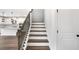 Staircase featuring wood steps, white risers, and a black iron railing leading to the upper level at 1356 Auburn Glen Rd, Dacula, GA 30019