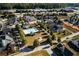 Aerial view of a neighborhood featuring a community pool, clubhouse, and tree-lined streets at 207 Tan Yard Rd, Social Circle, GA 30025