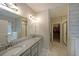 A luxurious bathroom offers double sinks, granite counters, a walk-in closet, and separate tub and shower at 207 Tan Yard Rd, Social Circle, GA 30025