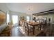 Bright dining room with a farmhouse table, chandelier, and hardwood floors is great for entertaining at 207 Tan Yard Rd, Social Circle, GA 30025
