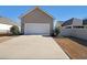 Detached two car garage, concrete driveway, and lush landscaping enhance this lovely homes curb appeal at 207 Tan Yard Rd, Social Circle, GA 30025