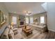 Cozy living room with fireplace, hardwood floors, neutral paint, and lots of natural light at 207 Tan Yard Rd, Social Circle, GA 30025