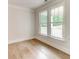 Bright bedroom with hardwood floors and double windows at 3292 Mill Forest Sw Dr, Conyers, GA 30094