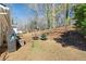 A spacious backyard with green grass, a fire pit, and several mature trees, offering privacy and shade at 4558 Ryan Rd, Conley, GA 30288
