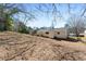 A large backyard, providing a blank canvas for landscaping and outdoor activities, next to an all-white house at 4558 Ryan Rd, Conley, GA 30288