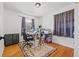 Bright bedroom with hardwood floors, ceiling fan, and window with curtains; currently used as a home office at 4558 Ryan Rd, Conley, GA 30288
