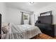 Bedroom with hardwood flooring and a large dresser with a TV on top at 4558 Ryan Rd, Conley, GA 30288