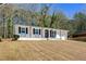 Inviting ranch-style house with a white brick facade and attached one-car garage at 4558 Ryan Rd, Conley, GA 30288