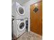 Laundry room features stackable washer and dryer, and a door at 4558 Ryan Rd, Conley, GA 30288