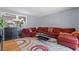 Comfortable living room featuring a large red sectional sofa and stylish decor at 4558 Ryan Rd, Conley, GA 30288