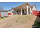 Spacious backyard featuring covered patio, shed, and lush green lawn at 2628 Songbird Ln, Grayson, GA 30017