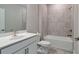 Well-lit bathroom with a single sink vanity, tiled shower-tub combo, and modern fixtures at 2628 Songbird Ln, Grayson, GA 30017
