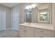 Bathroom with double sink vanity, large mirror, and tiled floors at 2628 Songbird Ln, Grayson, GA 30017