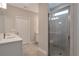 Bathroom featuring tiled shower with glass door and sink with modern fixtures at 2628 Songbird Ln, Grayson, GA 30017