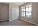 Cozy bedroom featuring neutral walls, carpeted floors, and natural light from a large window at 2628 Songbird Ln, Grayson, GA 30017