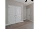 This bedroom features neutral walls, carpeted floors, a ceiling fan, and closet with double doors at 2628 Songbird Ln, Grayson, GA 30017