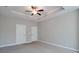Neutral toned bedroom with trey ceilings, fan, and two entry doors visible at 2628 Songbird Ln, Grayson, GA 30017