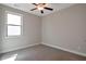 Comfortable bedroom with neutral walls, carpeted floors, a ceiling fan, and a bright window at 2628 Songbird Ln, Grayson, GA 30017