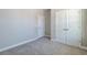 This bedroom features neutral walls, carpeted floors and a closet with double doors at 2628 Songbird Ln, Grayson, GA 30017