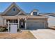 Charming home featuring a brick facade, two-car garage, and a well-manicured lawn at 2628 Songbird Ln, Grayson, GA 30017