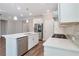 Modern kitchen with stainless steel appliances, white cabinets, a center island, and hardwood floors at 2628 Songbird Ln, Grayson, GA 30017