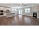 Open-concept living space with hardwood floors, a fireplace, and seamless connection to the kitchen at 2628 Songbird Ln, Grayson, GA 30017